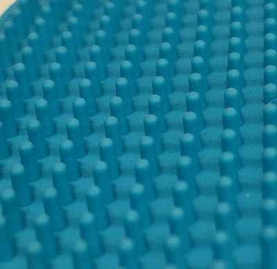 Close-up of a blue textured mat with raised bumps