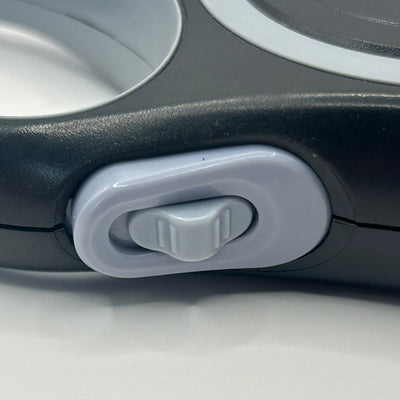 Close-up of a dog lead break button on a white background