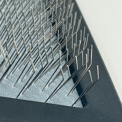 Close-up of a textured metal surface with small spikes