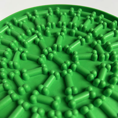 Green textured mat with green plastic bone shaped pieces on a white background