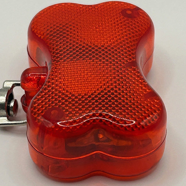 Red reflective safety light on a white background