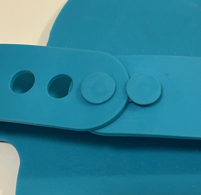 Close-up of a blue strap with circular holes on a white background