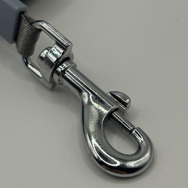 Metallic dog leash attachment on a gray background