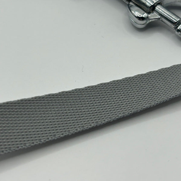 Gray strap with a metal buckle on a white background