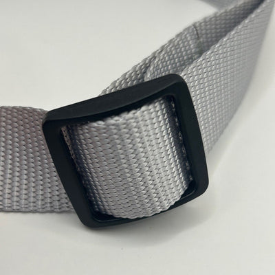 close up of grey collar size adjuster on white background