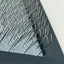 Close-up of a textured metal surface with small spikes