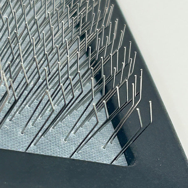 Close-up of a textured metal surface with small spikes