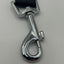 Metallic dog seat belt clip on a grey background