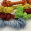 Colorful dog toy with ropes and yarn on a white background