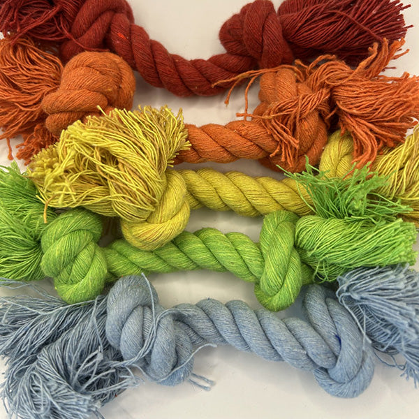 Colourful ropes and yarn arranged on a white background