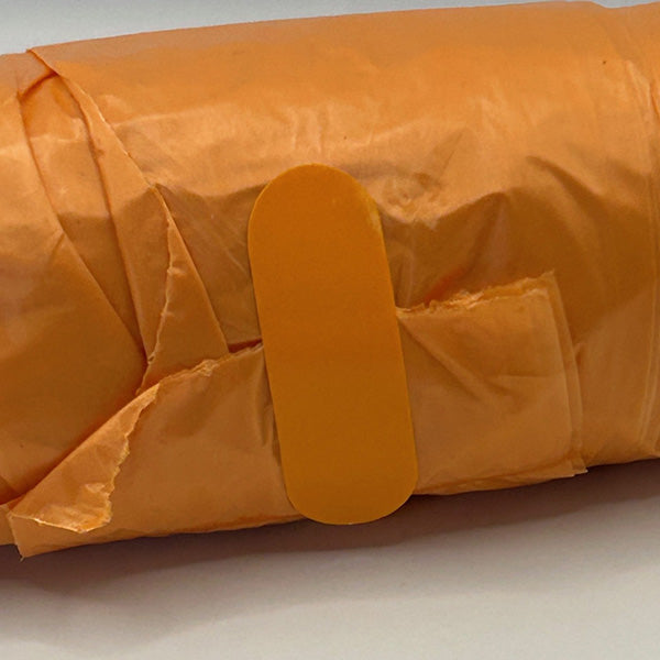 Orange roll of doggie bags with sticker detail